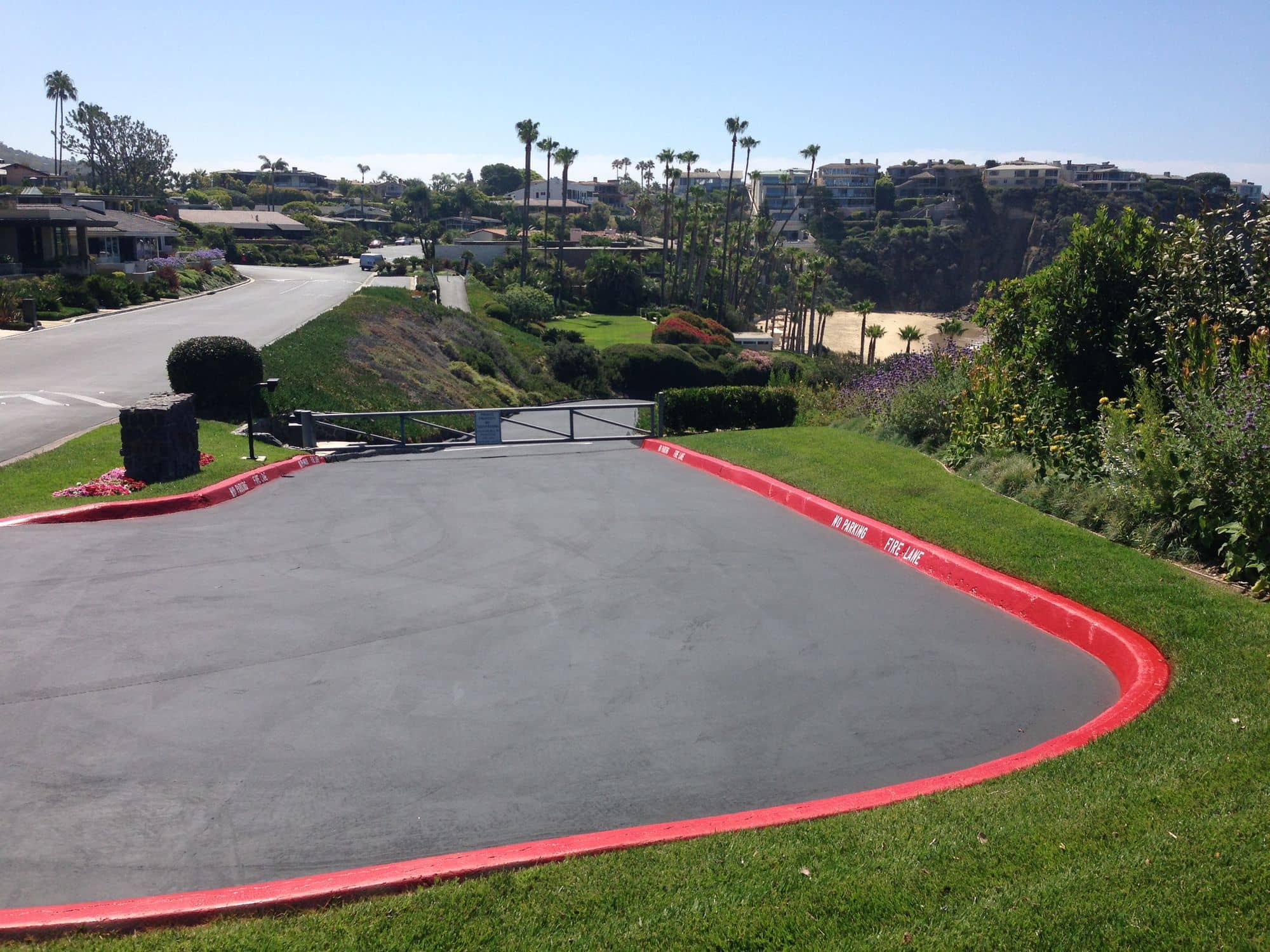 Sealed turnaround outlined by red curbs on a landscaped hillside