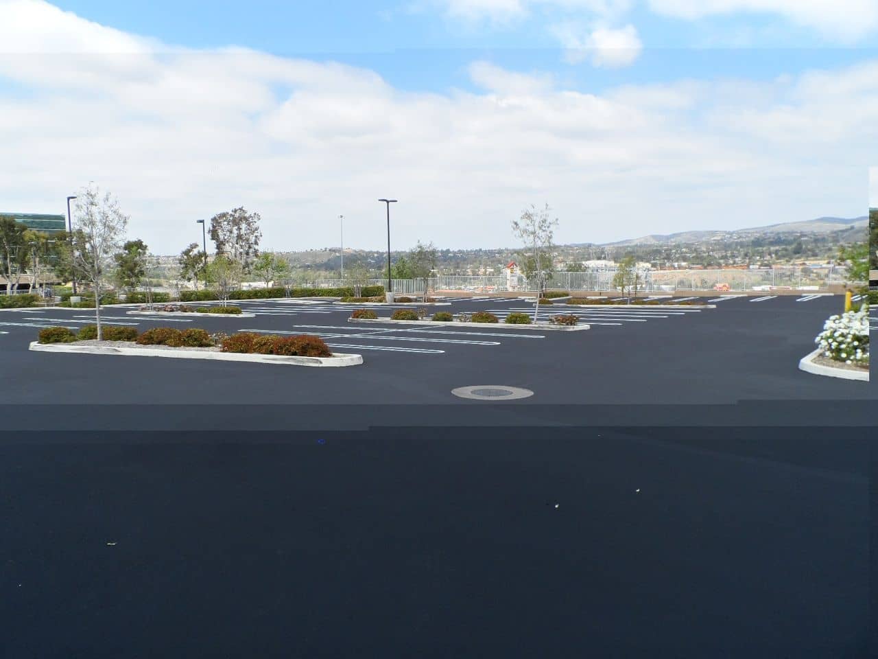Sealed parking terrace overlooking a hillside view under a bright sky
